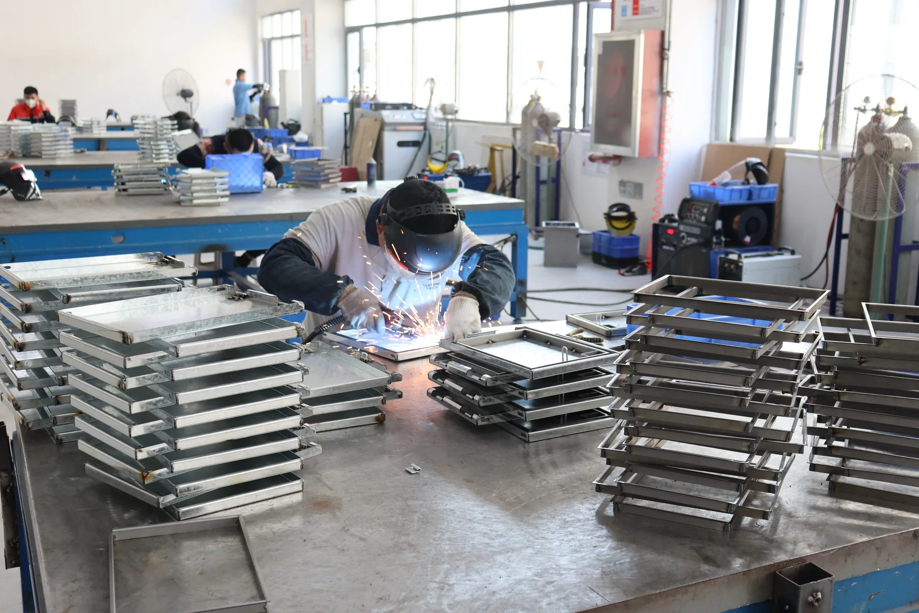 Cabinet frame welding and sheet-metal work visible in the Factory B source material